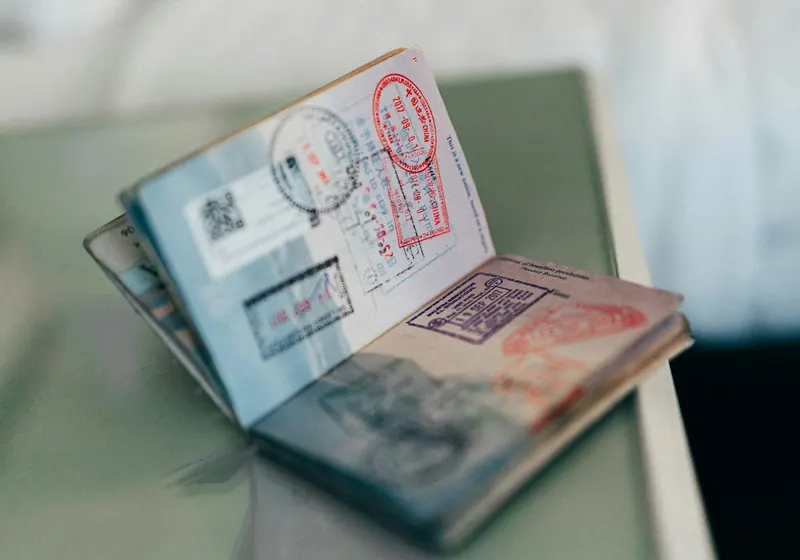 An open passport with stamps